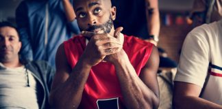 YouGov survey finds Americans lack trust in sporting integrity Basketball fans looking skeptical while watching a game