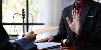 Hand rejecting envelope in judicial setting
