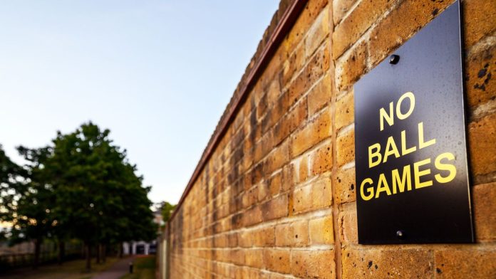 Crypto.com-quits-sports-in-several-states-amid-pushback A sign on a brick wall stating that playing ball games in the area is not allowed