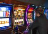 Slot jackpot tax increase will go into effect in time for 2026 taxes A man playing a slot machine in a casino