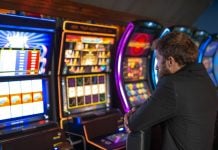 A man playing a slot machine in a casino