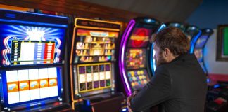 Slot jackpot tax increase will go into effect in time for 2026 taxes A man playing a slot machine in a casino