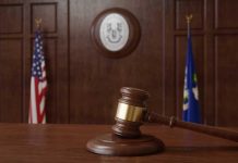 Kalshi takes Connecticut regulator to court over cease and desist letter Courtroom with US and Connecticut flagsI