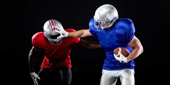 Football player strong arming another football player