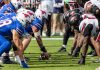 SMU Mustangs and Louisville Cardinals players face off during a NCAA football game