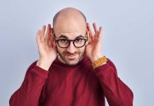 Man holding hands to both ears to indicate listening