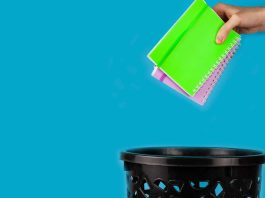 Notebooks being thrown in trash