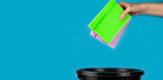 Notebooks being thrown in trash