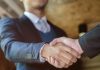 PrizePicks continues to build policy team with Zabriskie hiring A man shaking hands as PrizePicks hires a new member to its policy team.