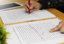 Hands with red pen editing document
