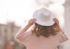 A person wearing a white hat as White Hat Studios expands its reach.