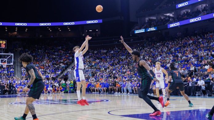 gameplAI-signs-up-TxODDS-to-power-AI-pricing-for-college-basketball A player shoots over a guard during an NCAA college basketball game