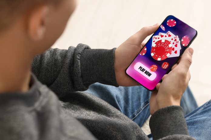 man playing online casino on phone