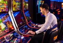 A man playing a slot machine in a casino