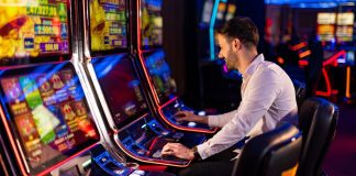 AGEM warns that state rollouts of slot jackpot threshold increase will take time A man playing a slot machine in a casino