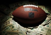 A NFL ball with money as the NBA guard Devin Booker bets on Super Bowl LX.