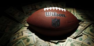 A NFL ball with money as the NBA guard Devin Booker bets on Super Bowl LX.