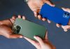 Gaming operators admit 1-800-GAMBLER changeover was tough to handle Two people swapping cellphones