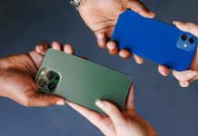Two people swapping cellphones
