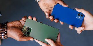 Gaming operators admit 1-800-GAMBLER changeover was tough to handle Two people swapping cellphones