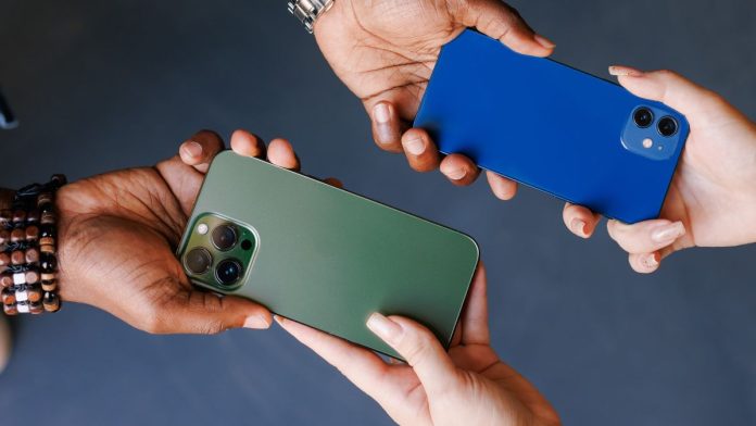 Gaming-operators-admit-1-800-GAMBLER-changeover-has-been-tough Two people swapping cellphones