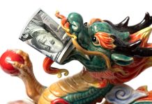 Ceramic dragon with $100 bill in mouth