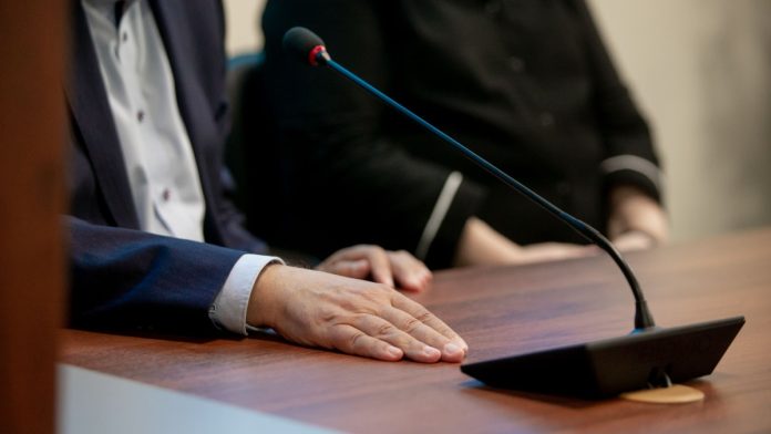 Maine-Hearing-Online-Sweepstakes-Bill-Ban A person talking into a microphone as Maine lawmakers hold a hearing on a potential online sweepstakes ban.