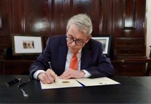 Ohio Gov. Mike DeWine signs a bill as he considers online sports betting his "biggest regret."