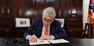 Ohio Gov. Mike DeWine signs a bill as he considers online sports betting his "biggest regret."