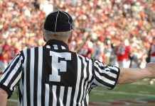 A football referee signaling a call