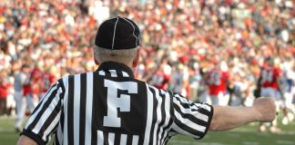 NCAA wants to be able to referee college sports prediction markets A football referee signaling a call