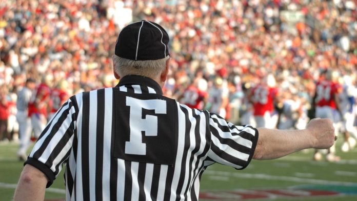 NCAA-wants-to-be-able-to-referee-college-sports-prediction-markets A football referee signaling a call