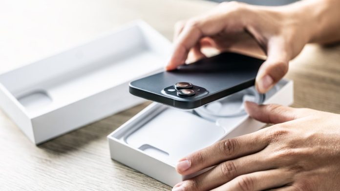 A person taking a brand new phone out of its box