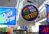 Signs for the New York Lottery and lottery games in a retail store