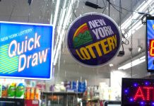 Signs for the New York Lottery and lottery games in a retail store