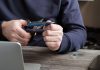 Virginia may consider banning credit cards for sports betting A person sat by a laptop cutting up a credit card