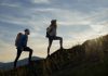 West Virginia sports betting, iGaming tax hikes on table for 2026 Two hikers silhouetted by the sun while walking up a mountain