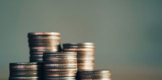Coins as Coinbase faces a lawsuit in Nevada over event contracts.