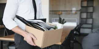 A person packing up their office as DraftKings is set to undergo a series of layoffs.