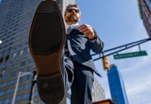 View from underneath of a businessman taking a stride forward