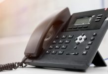 A phone as the NCPG calls on prediction markets to use its gambling helpline.