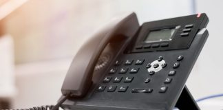 A phone as the NCPG calls on prediction markets to use its gambling helpline.