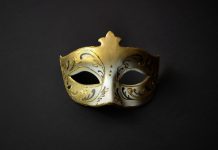 New York AG warns public that prediction markets are ‘masquerading’ A gold mask, like a guest might wear at a masquerade ball
