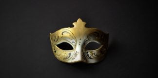 New York AG warns public that prediction markets are ‘masquerading’ A gold mask, like a guest might wear at a masquerade ball