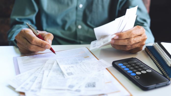 New-York-Monthly-Statement-Betting-Bill A person with bill statements as New York considers a bill that requires sportsbooks to send monthly activity statements to sports bettors.