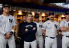 Aaron Judge and other New York Yankees players and staff in the locker room