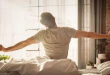 Sleeper re-awakens as prediction market through deal with Kalshi A man sits up and stretches in bed after waking up