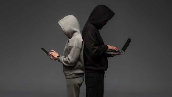 Two-CT-men-accused-of-$3M-bonus-bet-fraud-on-FanDuel-&-other-betting-sites Two masked hackers using laptops