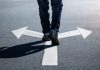 Virginia punts sweeps ban to 2027 as Indiana moves ahead A person walking on a road over arrows pointing in opposite directions