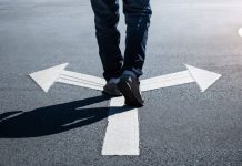 Virginia punts sweeps ban to 2027 as Indiana moves ahead A person walking on a road over arrows pointing in opposite directions